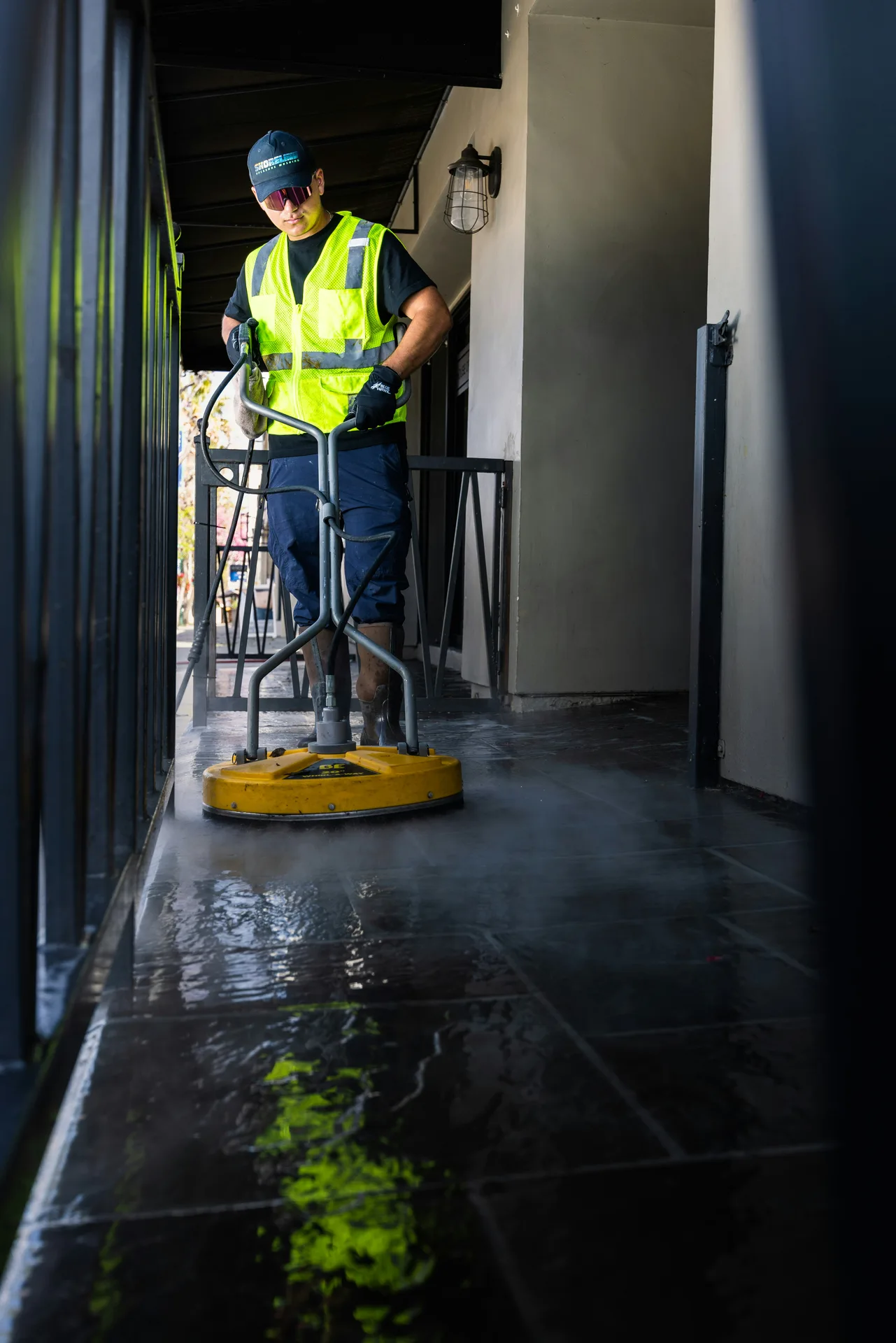 Technician Using Surface Cleaner on /oil-stain-removal/ — Hartford Pressure Washing Calgary